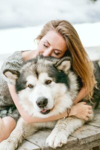 dog cuddles with owner