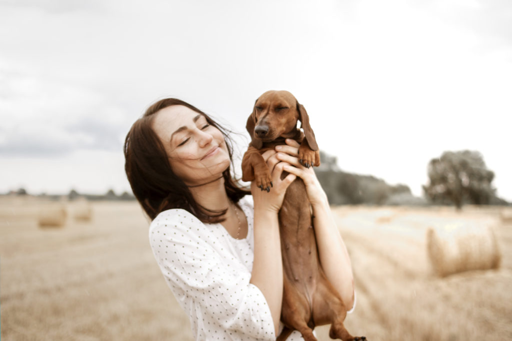 Lady holding a dachshund